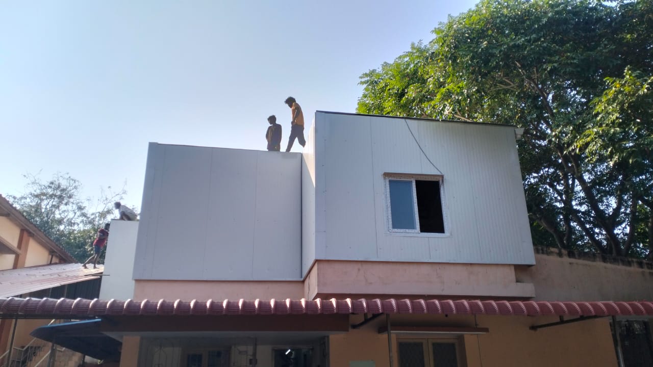 PUF sandwich roofing sheet installation by Arasuvel Roofings for industrial building with insulated wall panels